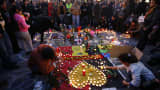 People gather around a memorial in Brussels following bomb attacks in Brussels, Belgium, March 22, 2016.