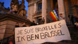People display a solidarity banner on the steps of the old stock exchange building in Brussels following bomb attacks in Brussels, Belgium, March 22, 2016. Banner reads "I am Brussels" in French and in Flemish languages.