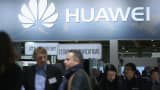 Visitors crowd the Huawei stand at the 2016 CeBIT digital technology trade fair on the fair's opening day.