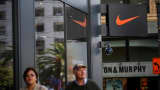 Pedestrians walk by a Nike store