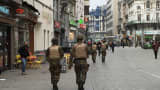 Belgian military forces patrol tourist streets in Brussels.