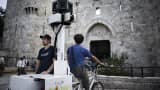 The picture shows a tricycle with a mounted camera to capture images for Google Street in front of Damascus Gate in the
