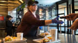 A worker takes a pager from a customer at a Shake Shack restaurant in Bridgewater, New Jersey.