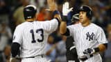 Carlos Beltran of the New York Yankees is congratulated by teammate Alex Rodriguez after hitting a three-run home run against the Chicago White Sox.