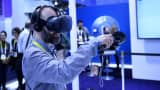 An attendee demonstrates the HTC Vive virtual reality (VR) headset during the 2016 Consumer Electronics Show (CES) in Las Vegas, Nevada.