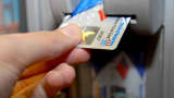 A Bank of America customer uses a bank card