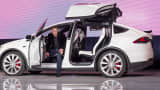 Elon Musk, chairman and chief executive officer of Tesla Motors, exits the Model X sport utility vehicle during an event in Fremont, California, Sept. 29, 2015.