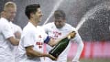 Poland's Robert Lewandowski sprays Champagne as he and his team mates celebrate after winning the Euro 2016 group D qualification soccer match.