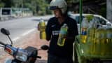 A villager carries bottles of petrol oil at a village in Hulu Langat, outside Kuala Lumpur on April 18, 2016. Oil prices plunged on April 18 after the world's top producers failed to reach an agreement on capping output aimed at easing a global supply glut, sparking fears it could set off another round of price.