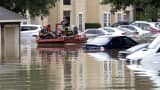 Residents are evacuated from their flooded apartment complex Tuesday, April 19, 2016, in Houston. Storms have dumped more than a foot of rain in the Houston area, flooding dozens of neighborhoods.