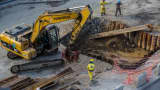 A Caterpillar Inc. excavator moves some materials at a Brazil Rapid Transit (BRT) construction site in Rio de Janeiro, Brazil.