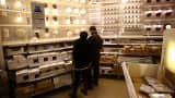 Customers look at lighting fixtures in Ikea