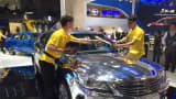 The mirrored finish on the Raeton, manufactured by China's Changan Auto, requires two attendants to maintain maximum shine