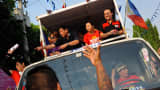 Philippine presidential candidate Rodrigo Duterte (L) gestures to the crowd during a campaign motorcade on April 27, 2016 in Manila. The brash, tough-talking mayor of Davao on the southern island of Mindanao has been the surprise pre-election poll favorite pulling away from his rivals despite controversies. Duterte has shocked the political establishment with his unorthdox style of campaigning and his profanity-laced campaign speeches.