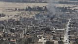 Smoke rises from the modern city of Palmyra, in Homs Governorate, Syria April 1, 2016.