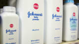 Bottles of Johnson & Johnson baby powder line a drugstore shelf in New York.