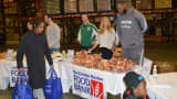 Volunteers from the NBA's Celtics, including assistant coach Walter McCarty, distribute food at the Greater Boston Food Bank.