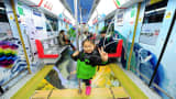 A young girl gives the victory sign on a healthy and happy themed subway train is seen on March 5, 2015 in Hangzhou, Zhejiang province of China.