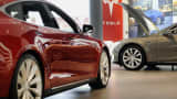 Model S P85D, right, and Model S 85 electric vehicles (EV) sit on display at the Tesla Motors Inc. retail store in San Jose, California.