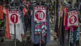 Sale signs are displayed on racks of clothing along the Fulton Street Mall in the Brooklyn borough of New York.