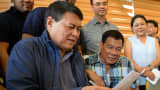 A May 16 photo of Philippines' president-elect Rodrigo Duterte (seated, right) with property magnate and former senator Manny Villar during a press conference in Davao City. Business titans, turncoat politicians, celebrities and rebel leaders have descended on the long-neglected far southern Philippines, hoping to gain favor with the nation's shock new powerbroker.