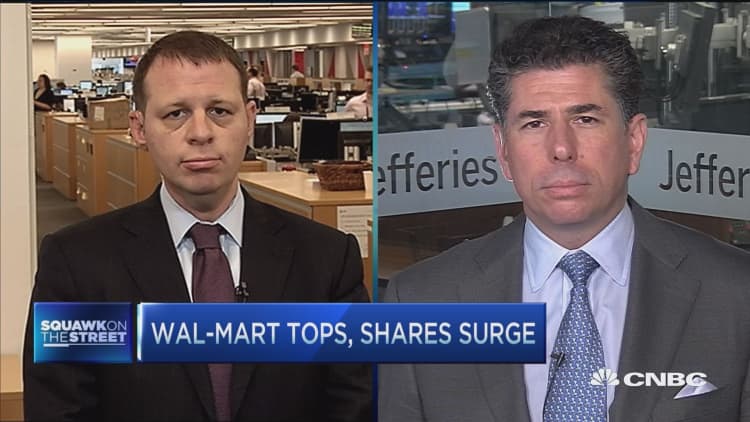 Wal-Mart tops, shares surge