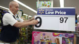 A Walmart employee changes a price at a store in Miami.