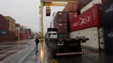 Workers load containers onto trucks from a cargo ship at a port in Jaragua do Sul, Santa Catarina state, Brazil.