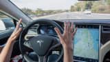 A member of the media test drives a Tesla Motors Model S car equipped with Autopilot in Palo Alto, California.