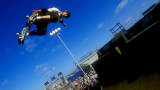 Tony Hawk grabs his skateboard vertical as he jumps from the ramp during the X-Games in San Diego, California.