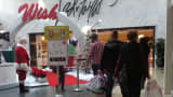 Shoppers walk past the Santa Claus photo booth in at the Westfield Mall in Annapolis, Maryland.