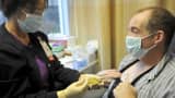 A patient receives an injection of chemotherapy during a treatment
