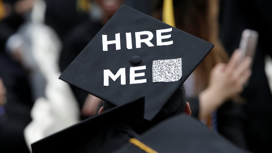 A graduating student of the City College of New York wears a message on his cap  that says "Hire Me" with a QR code during the College's commencement ceremony in the Harlem section of Manhattan.