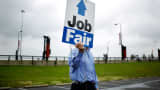 A Job News USA employee directs job seekers to a career fair at Papa John's Cardinal Stadium in Louisville, Kentucky.