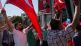People wave Turkish flags during a march around Kizilay Square in reaction to the attempted military coup on July 16, 2016 in Ankara, Turkey.