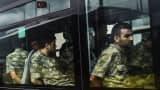Detained Turkish soldiers who allegedly took part in a military coup arrive in a bus at the courthouse in Istanbul on July 20, 2016, following the military coup attempt of July 15.