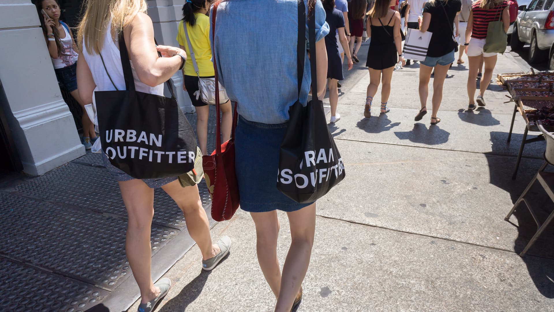 Shoppers with their Urban Outfitters shopping bags in Soho in New York