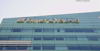 Ernst & Young settles charges tied to former employees