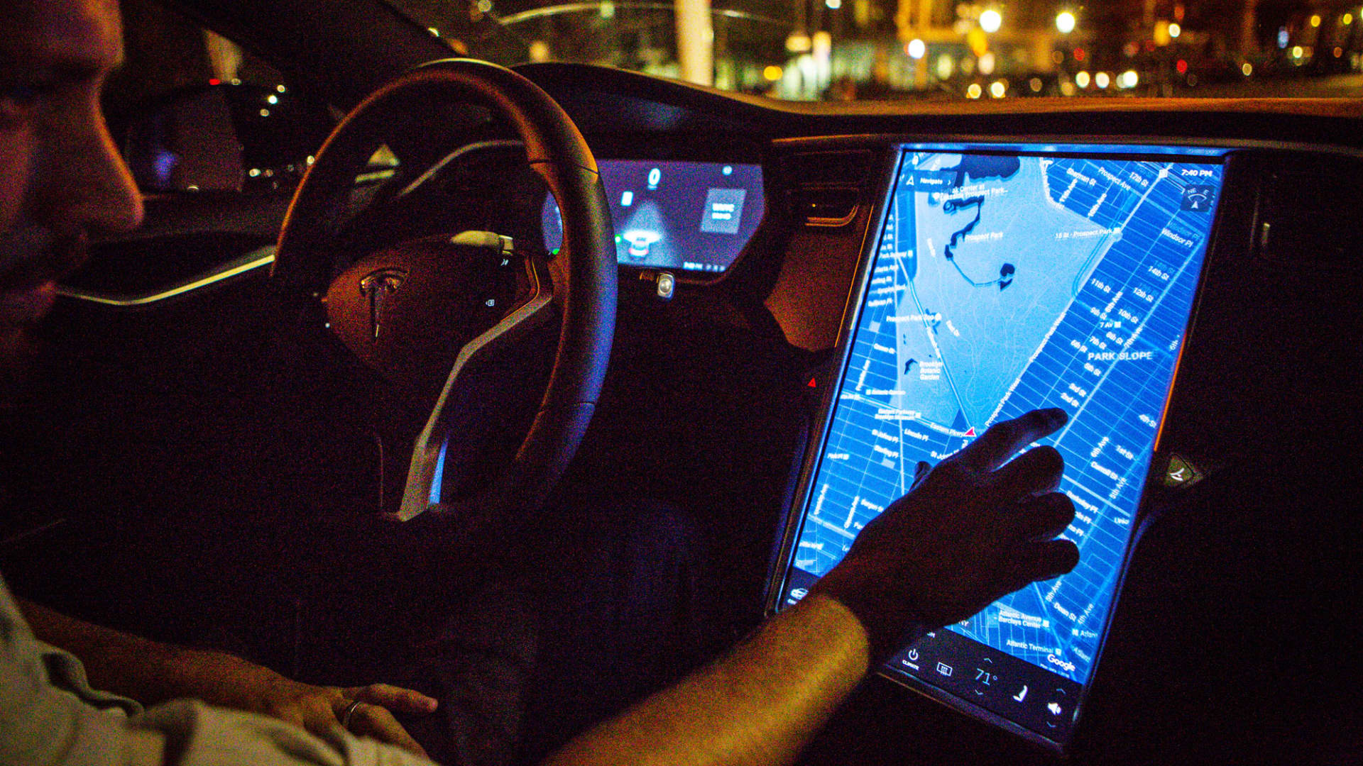 A driver uses the map navigation feature on a touchscreen control panel with the Tesla Motors Inc. 8.0 software update inside a Tesla Model S P90D vehicle.