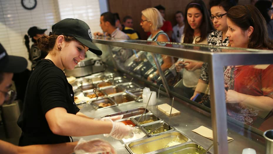 Chipotle restaurant workers fill orders for customers in Miami, Florida.