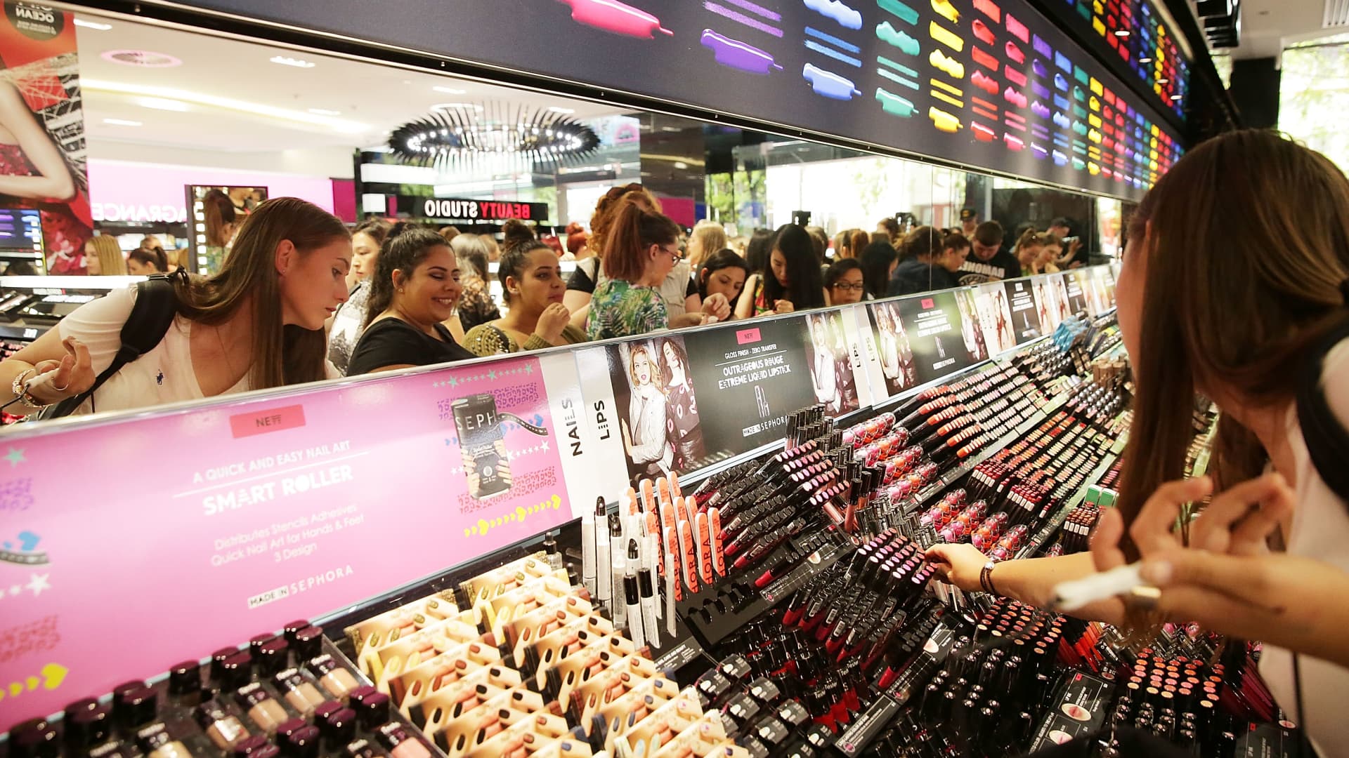 Customers shop for makeup at a Sephora store.