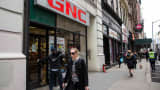 People walk past a GNC store in New York City.