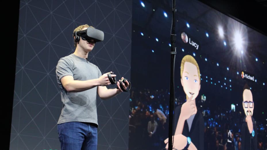 Facebook co-founder and chief executive, Mark Zuckerberg, speaks at an Oculus developers conference while wearing a virtual reality headset in San Jose, California.