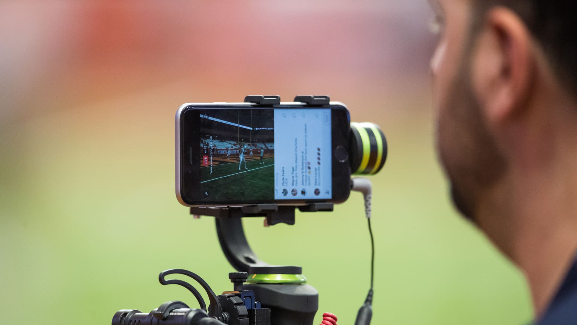 A television video person uses an iphone and stabilizer to film for facebook live broadcast before the game between the Syracuse Orange and the Louisville Cardinals on September 9, 2016 at The Carrier Dome in Syracuse, New York.