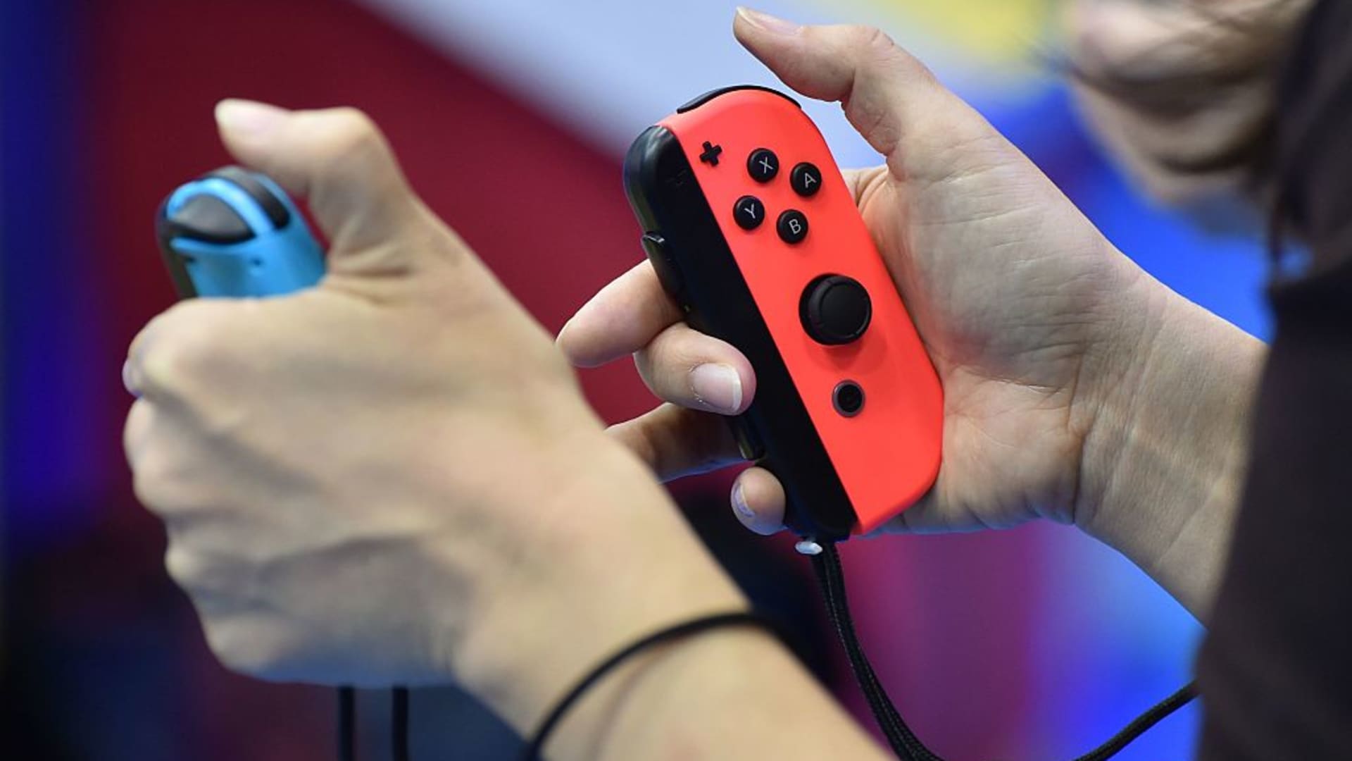 Visitors play Nintendo's new video game console Switch during its presentation in Tokyo.