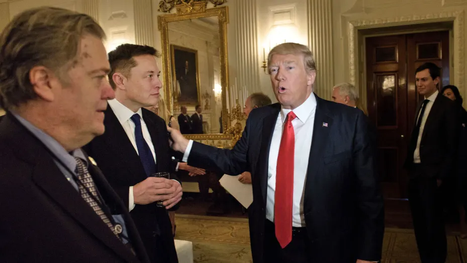 Trump advisor Steve Bannon (L) watches as President Donald Trump greets Elon Musk, SpaceX and Tesla CEO, before a policy and strategy forum with executives in the State Dining Room of the White House February 3, 2017 in Washington, DC.