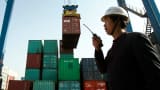 A worker monitors the loading of shipping containers at the new container port in Wuhan, in central China's Hubei province.
