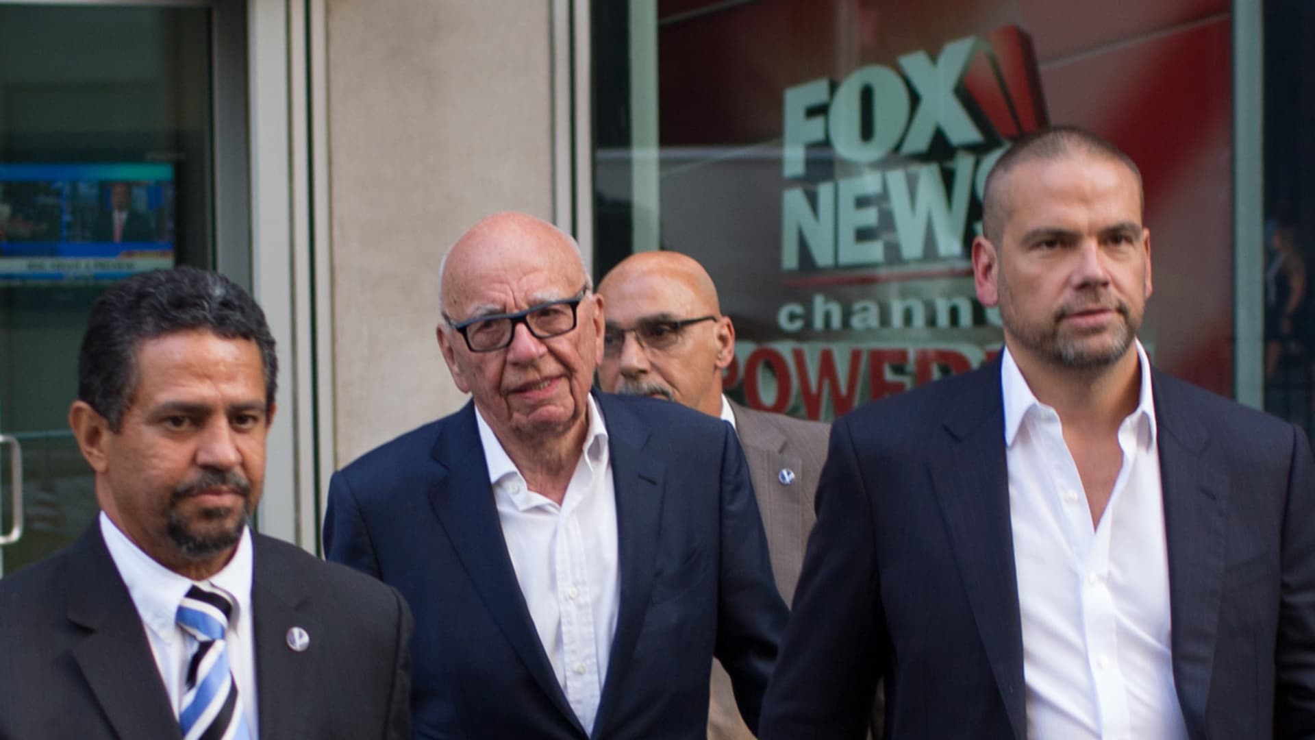 Rupert Murdoch leaves the News Corporation building with his son Lachlan Murdoch (R) on July 21, 2016 in New York City.