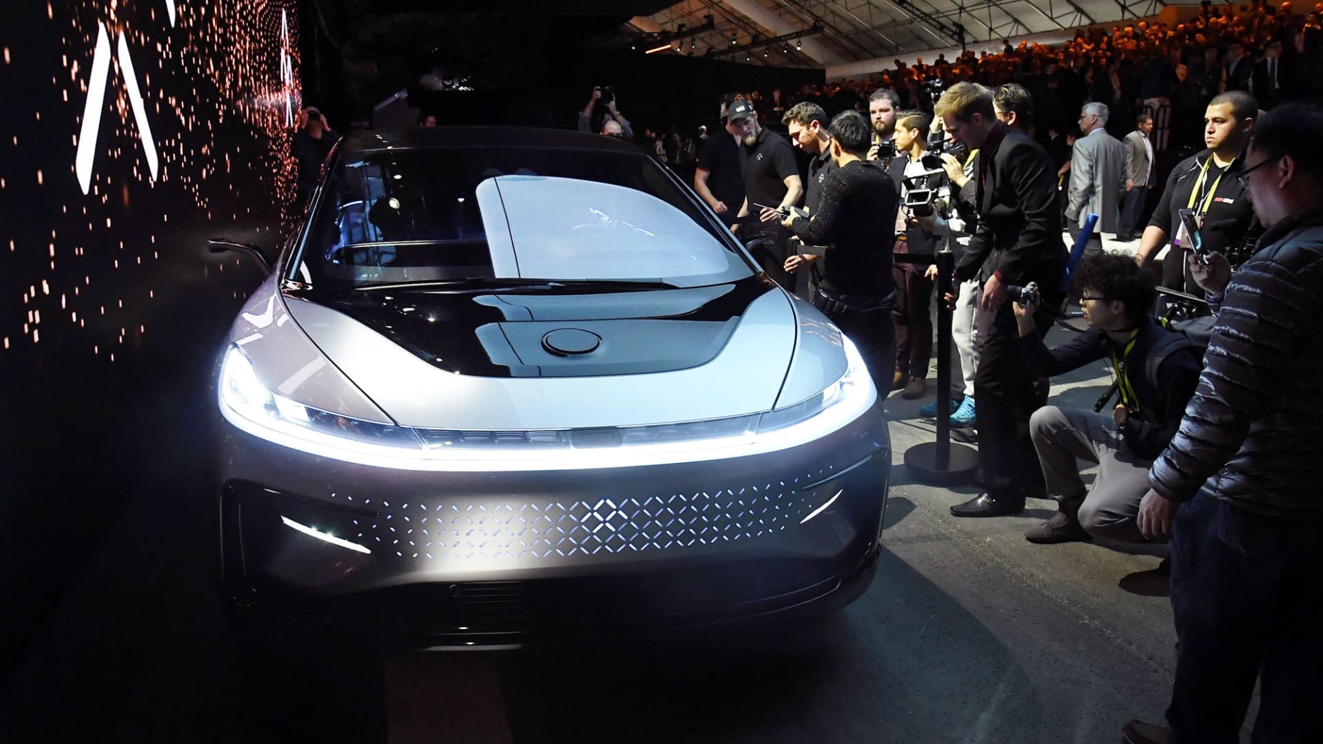 Attendees look at Faraday Future's FF 91 prototype electric crossover vehicle after it was unveiled at CES 2017 on January 3, 2017, in Las Vegas.
