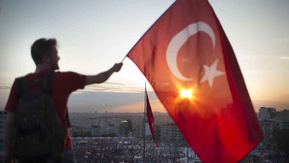 A man holding a Turkish flag.